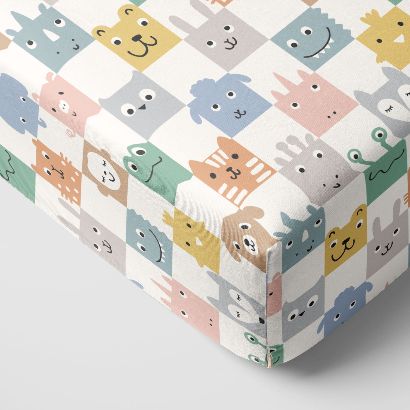 Close up image of a Check Mates Fitted Crib Sheet on the corner of a mattress