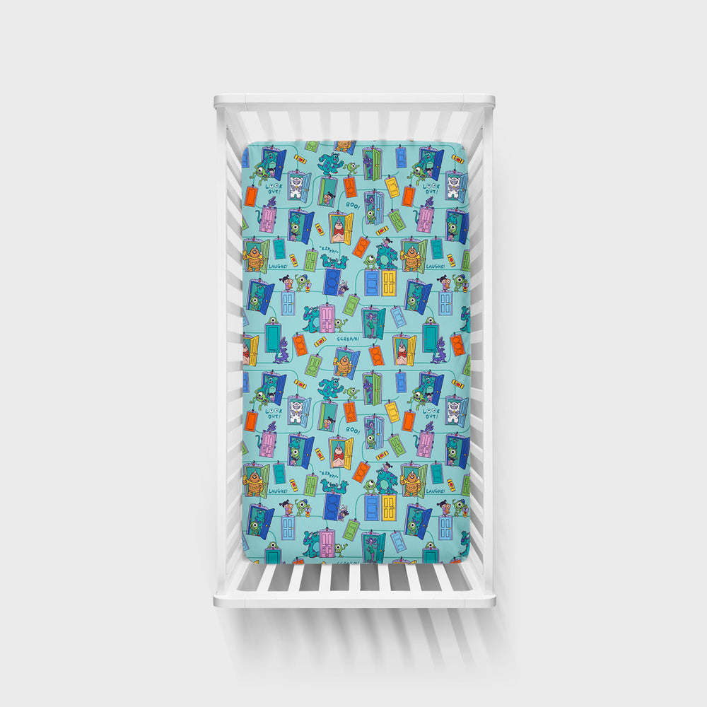 Top view image of the Disney Monsters, Inc. Scream Team Fitted Crib Sheet in a white crib