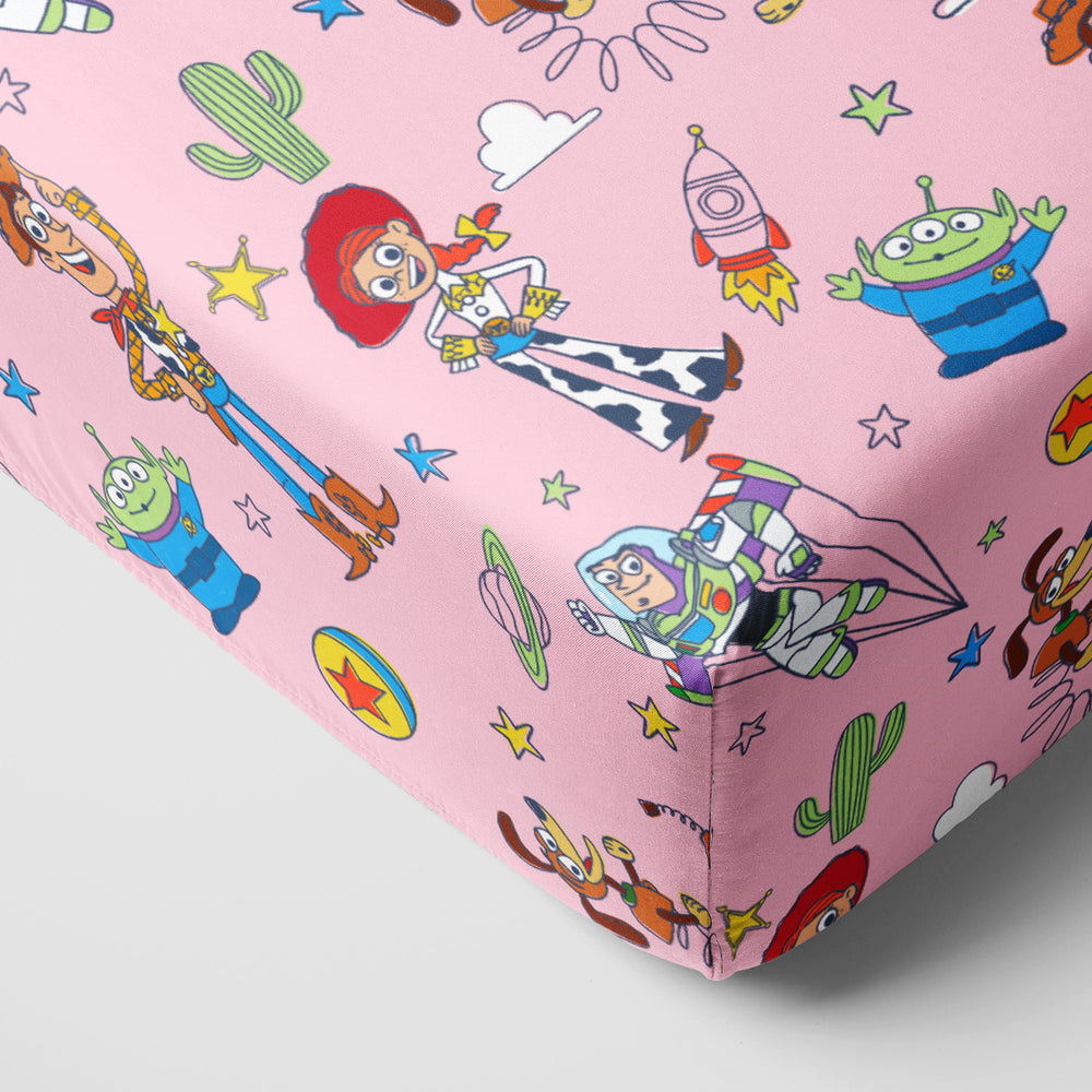 Corner image of Pink Toy Story Stars crib sheet