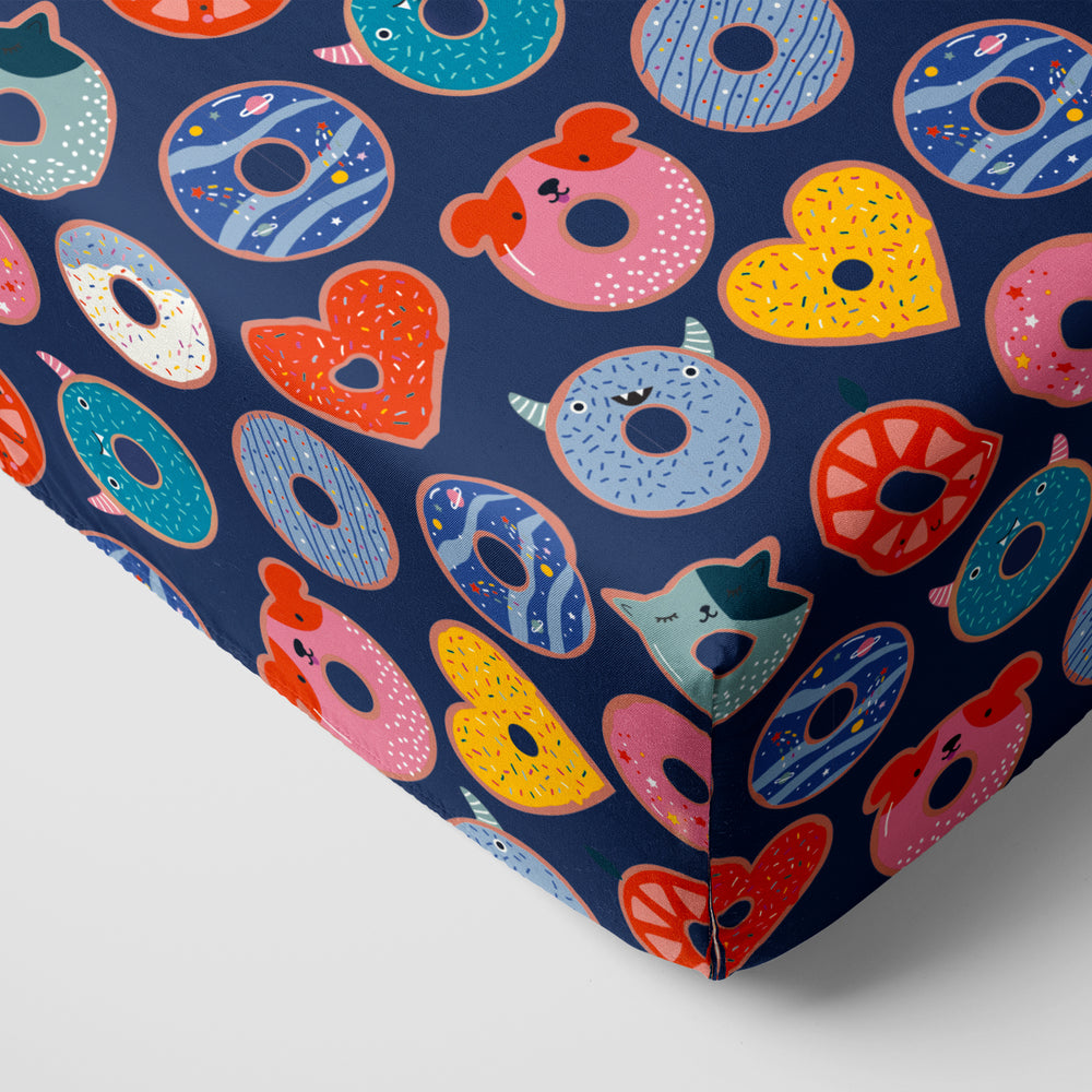 Corner view of Blue Donut Dreams Fitted Crib Sheet