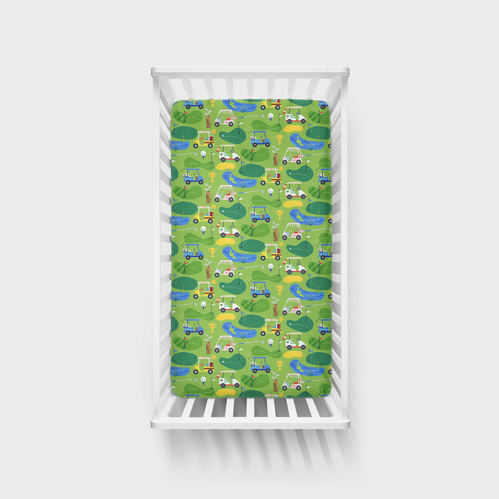 Overhead view of a Fairway Fun fitted crib sheet on a mattress in a crib