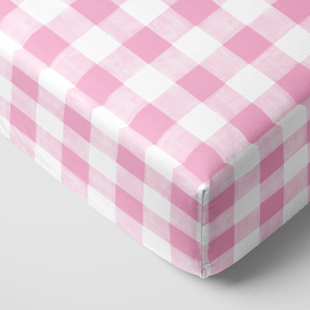 Click to see full screen - Corner view of a Pink Gingham fitted crib sheet