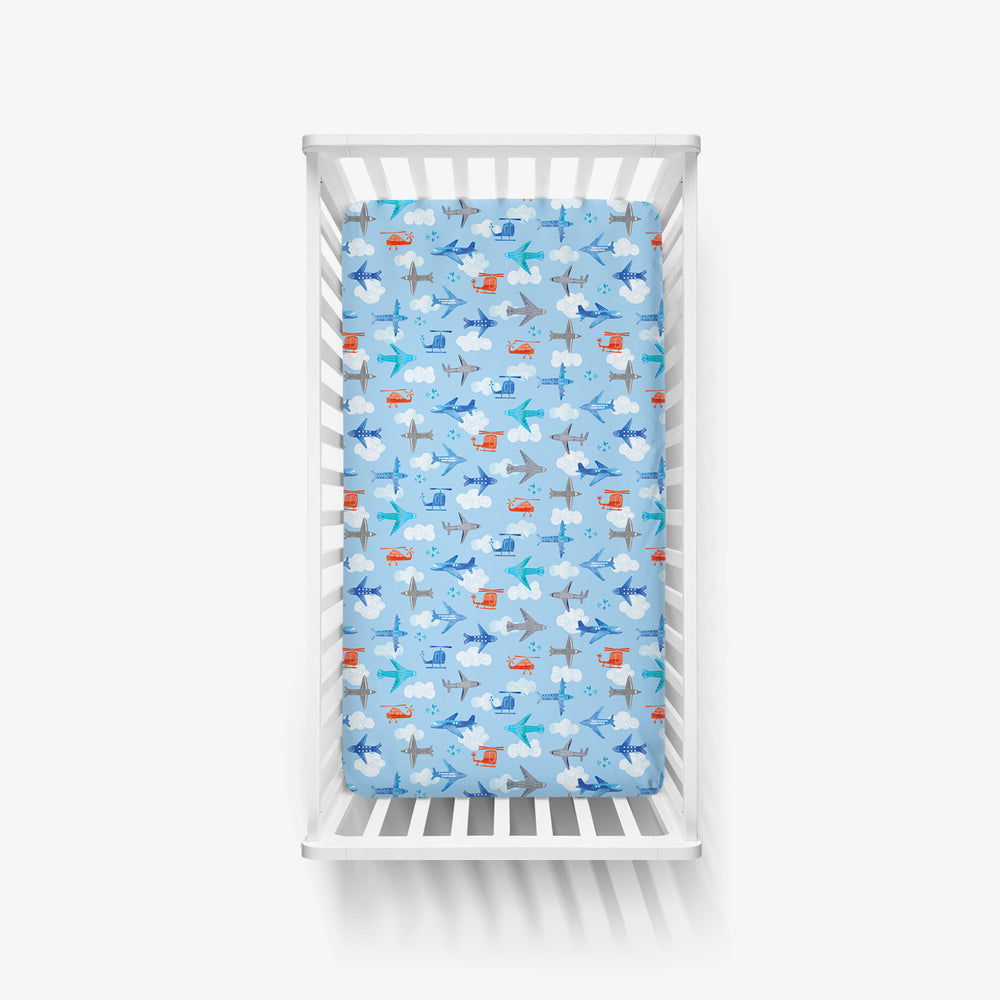 Top view of a Lets Fly crib sheet in a white crib