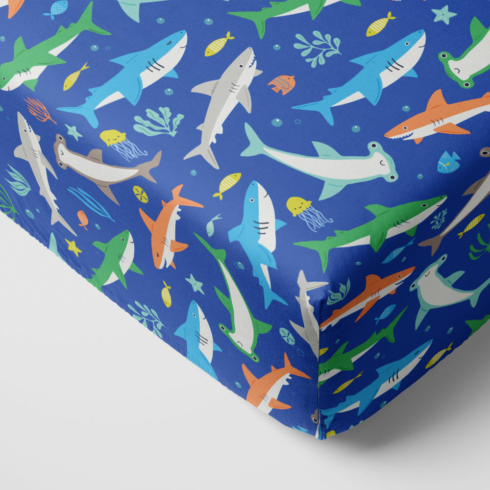 Close up image of a Rad Reef fitted crib sheet on a mattress