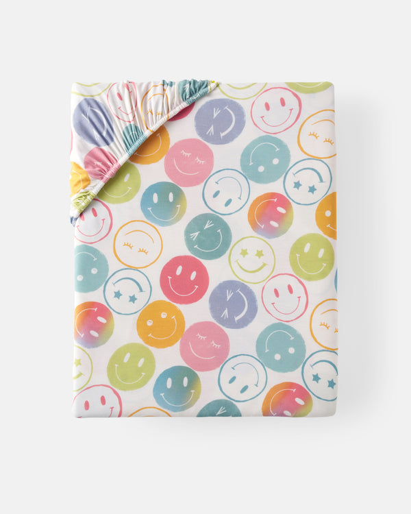 Flat lay of the standard Positive Vibes Fitted Crib Sheet