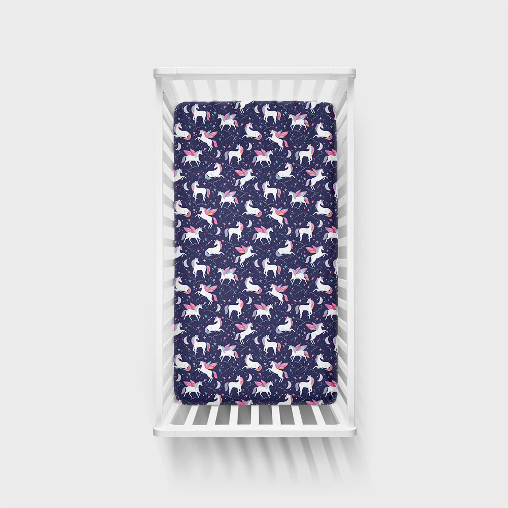 Top view of a Magical Skies Fitted Crib Sheet in a white crib