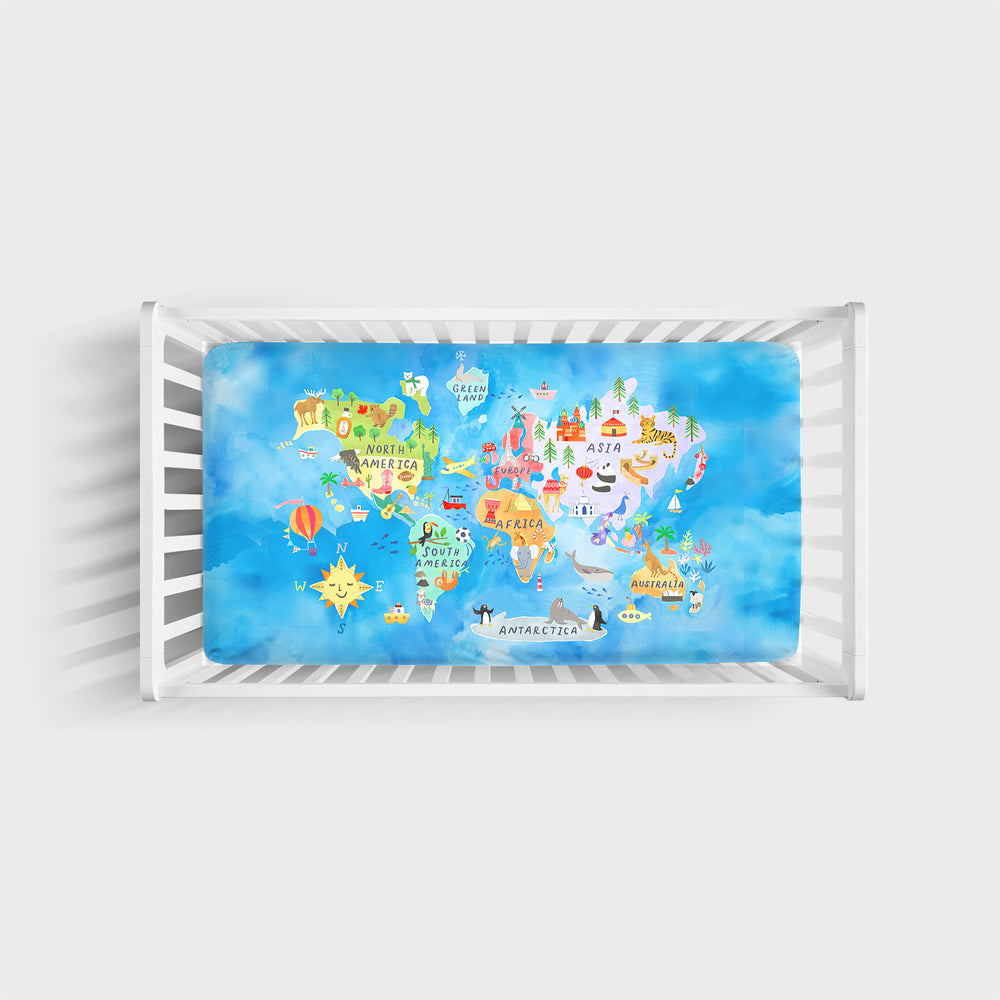 Top view image of an Around the World Fitted Crib Sheet in a white crib sheet