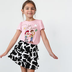 Child wearing a Disney & Pixar Jessie & Woody Puff Sleeve Tee and Moo Crew Ruffle Skort