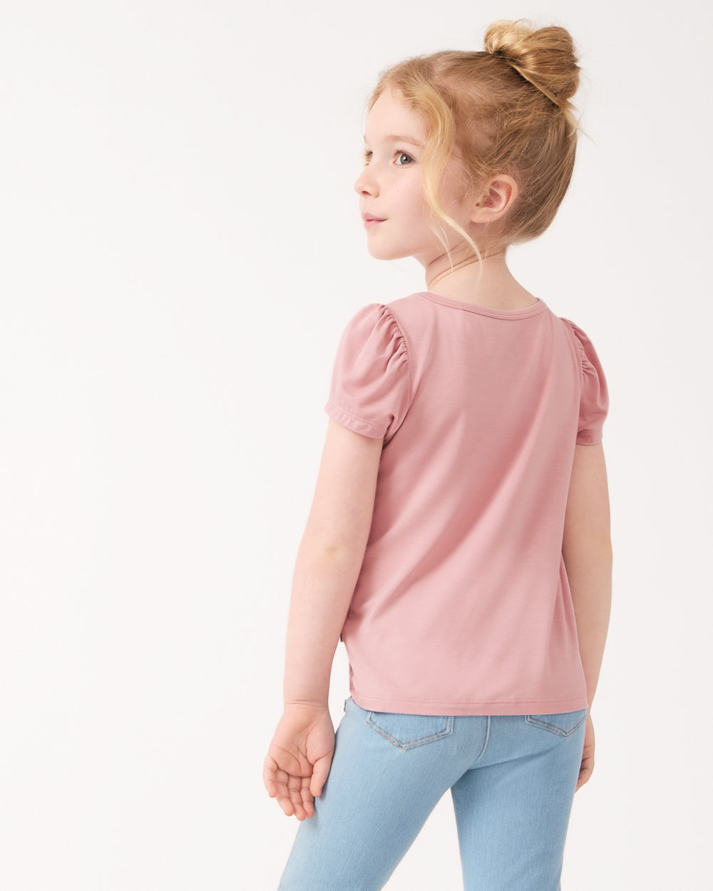 Back view of young girl wearing the Mauve Blush Puff Sleeve Tee