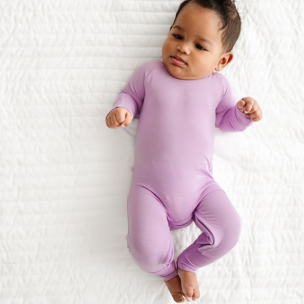 Child laying on bed wearing a Light Orchid Crescent Zippy