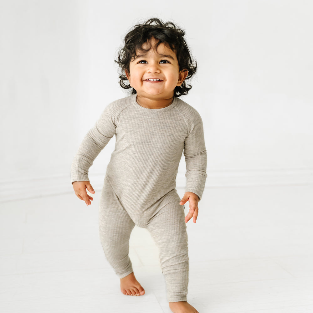 Child wearing a Heather Stone Ribbed crescent zippy