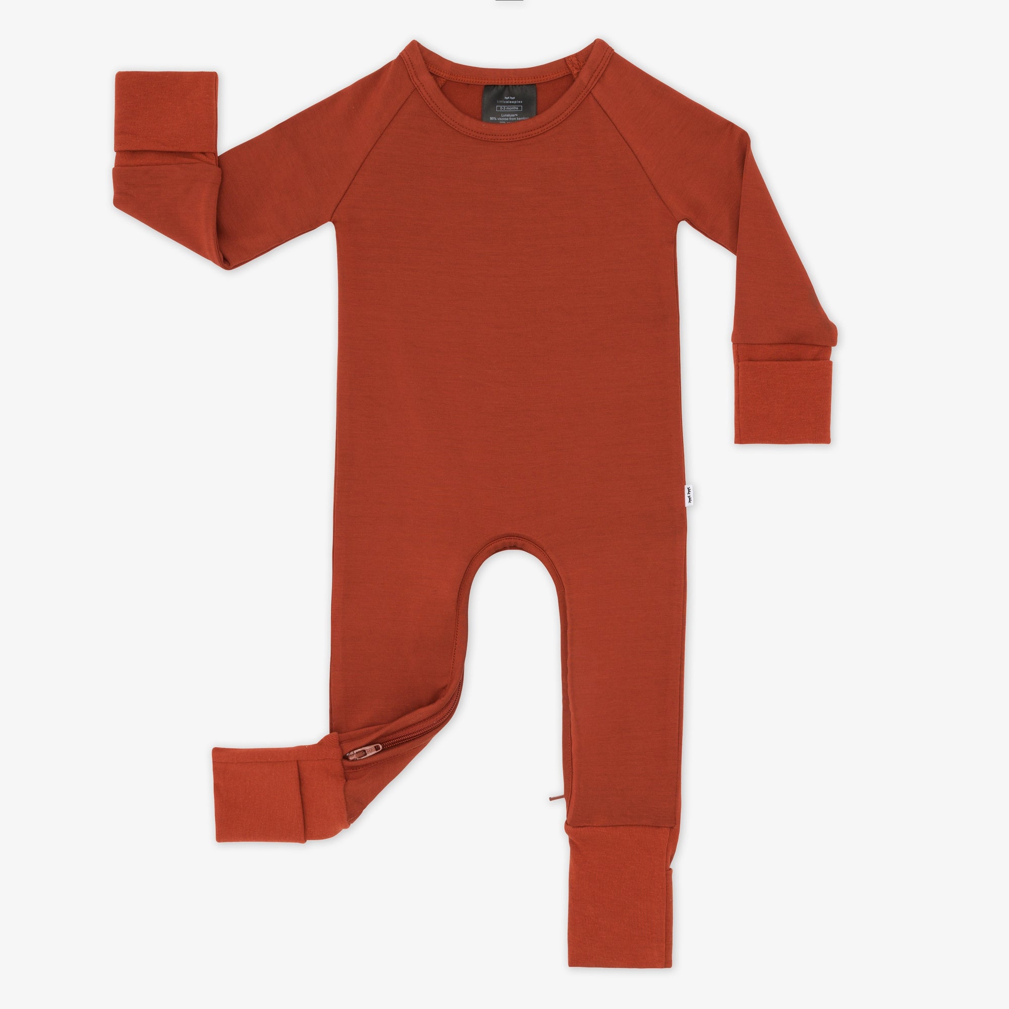 Flat lay image of a Cozy Rust crescent zippy