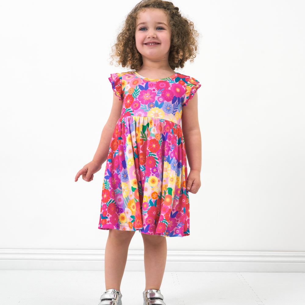 Child wearing a Rainbow Blooms flutter twirl dress