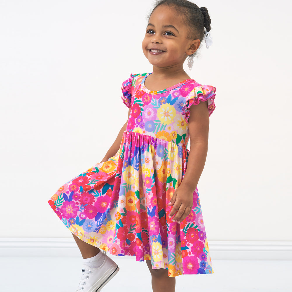 Alternate image of a child wearing a Rainbow Blooms flutter twirl dress