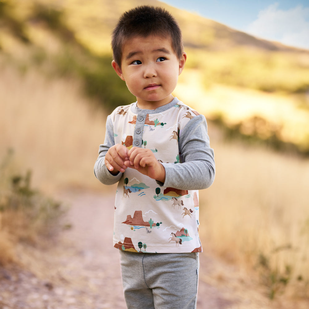 Boy outdoors while wearing the Trail Blazers Henley Tee and Heather Gray Jogger