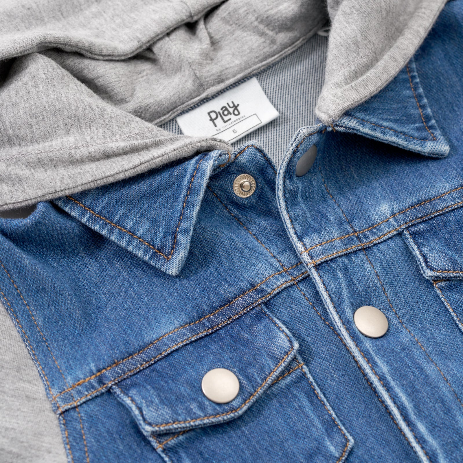Close up image of the collar & upper button details on the Midwash Blue/Gray Denim Jacket