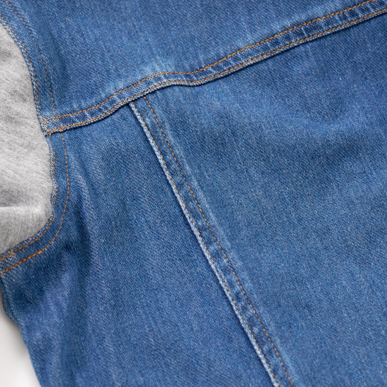 Close up image of the back seam details on the Midwash Blue/Gray Denim Jacket