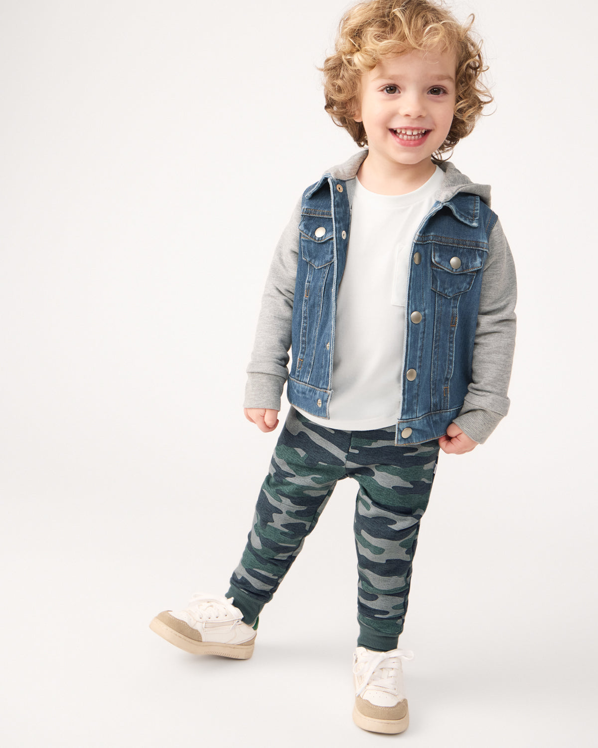 Boy wearing the Vintage Camo Jogger with a hooded trucker jacket and white tee