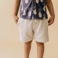 Close up image of a child wearing Bone Drawstring Shorts