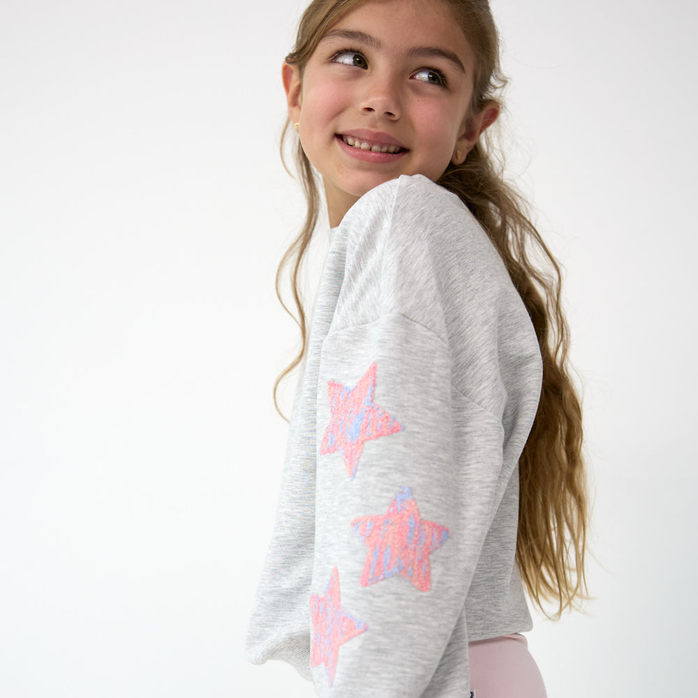 Smiling girl posing in the Light Heather Gray Drop Shoulder Crewneck