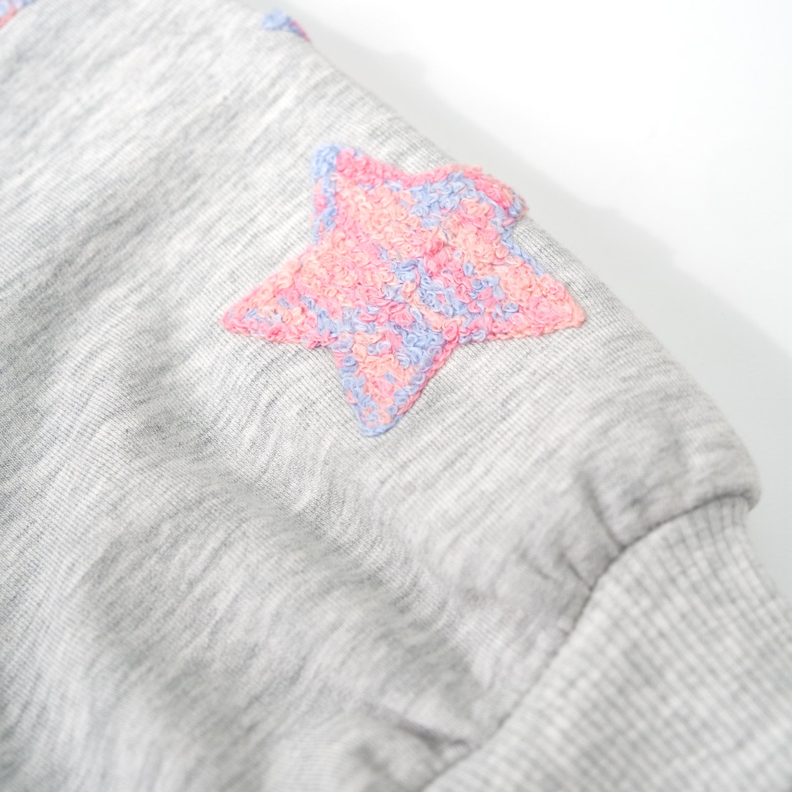 Alternate close up detail shot of the Light Heather Gray Drop Shoulder Crewneck detailing the stars on the sleeve