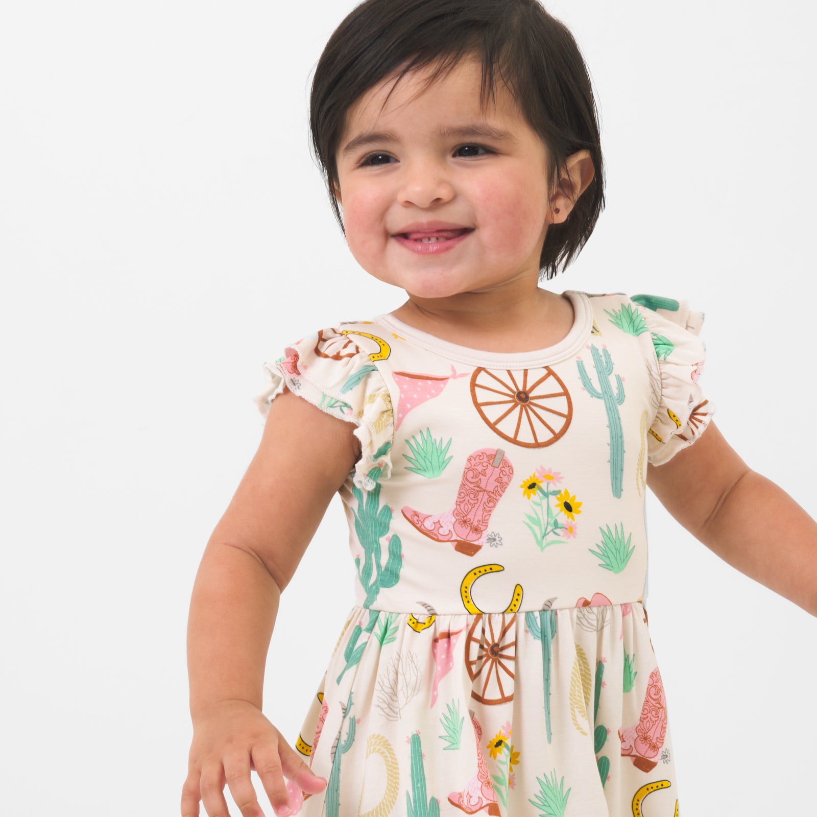 Close up image of a child wearing a Pink Ready to Rodeo twirl dress with bodysuit