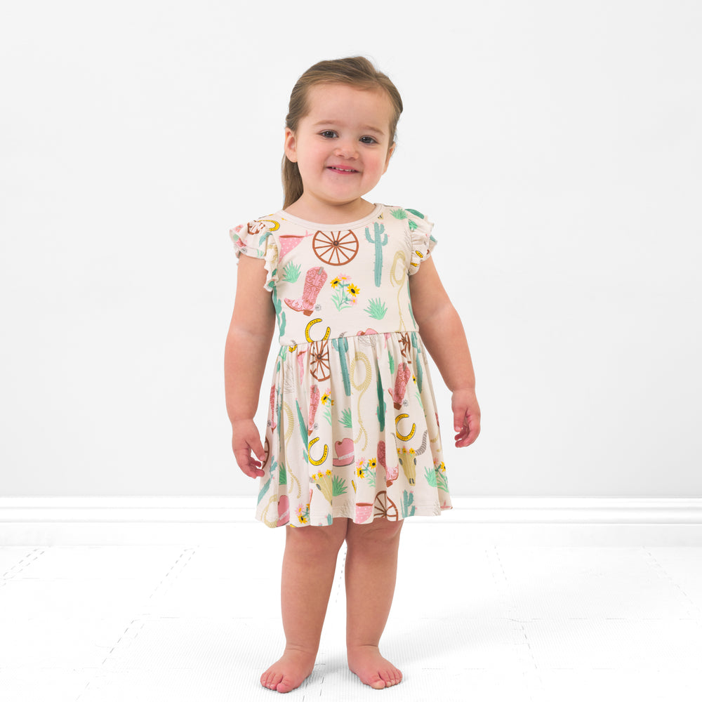 Child wearing a Pink Ready to Rodeo twirl dress with bodysuit