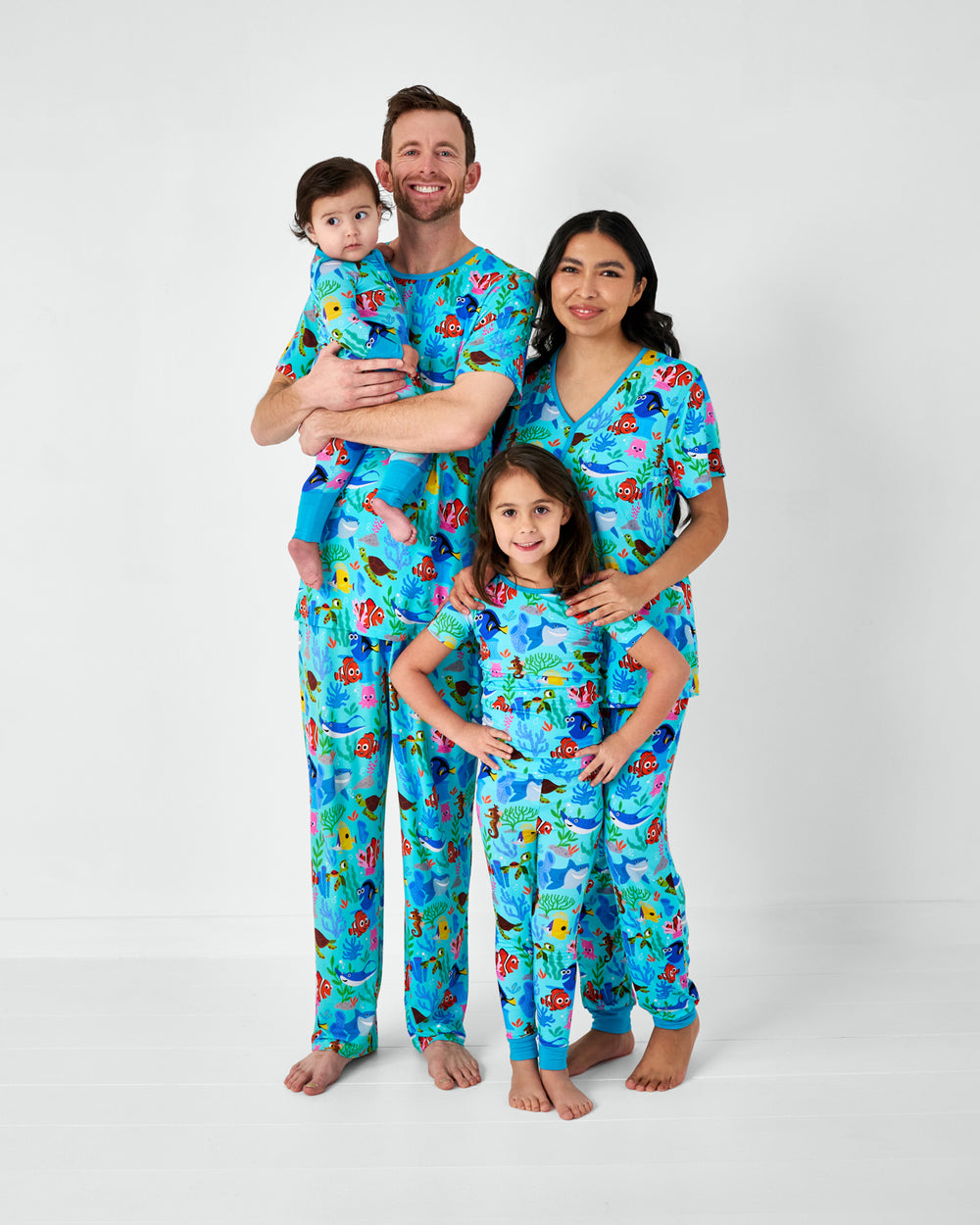 Family of four wearing Nemo's Reef matching bamboo pajamas