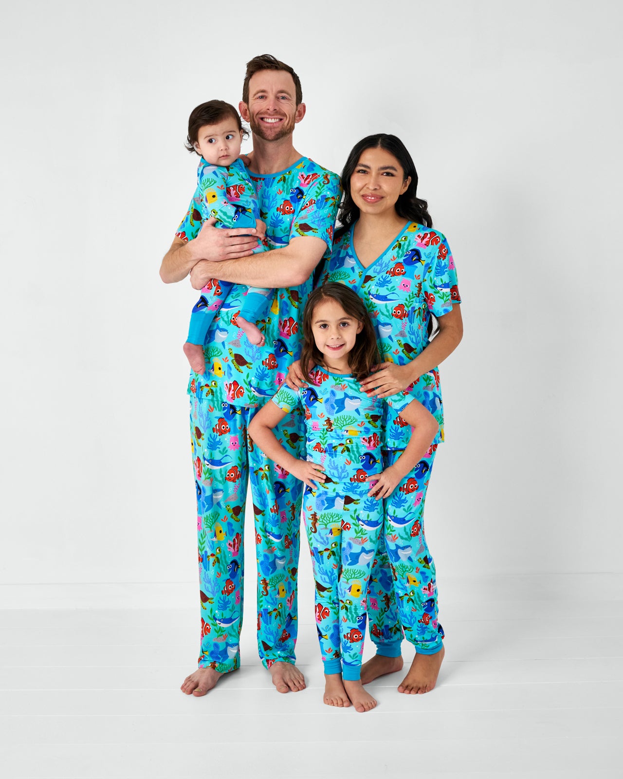 Family of four wearing Nemo's Reef matching bamboo pajamas