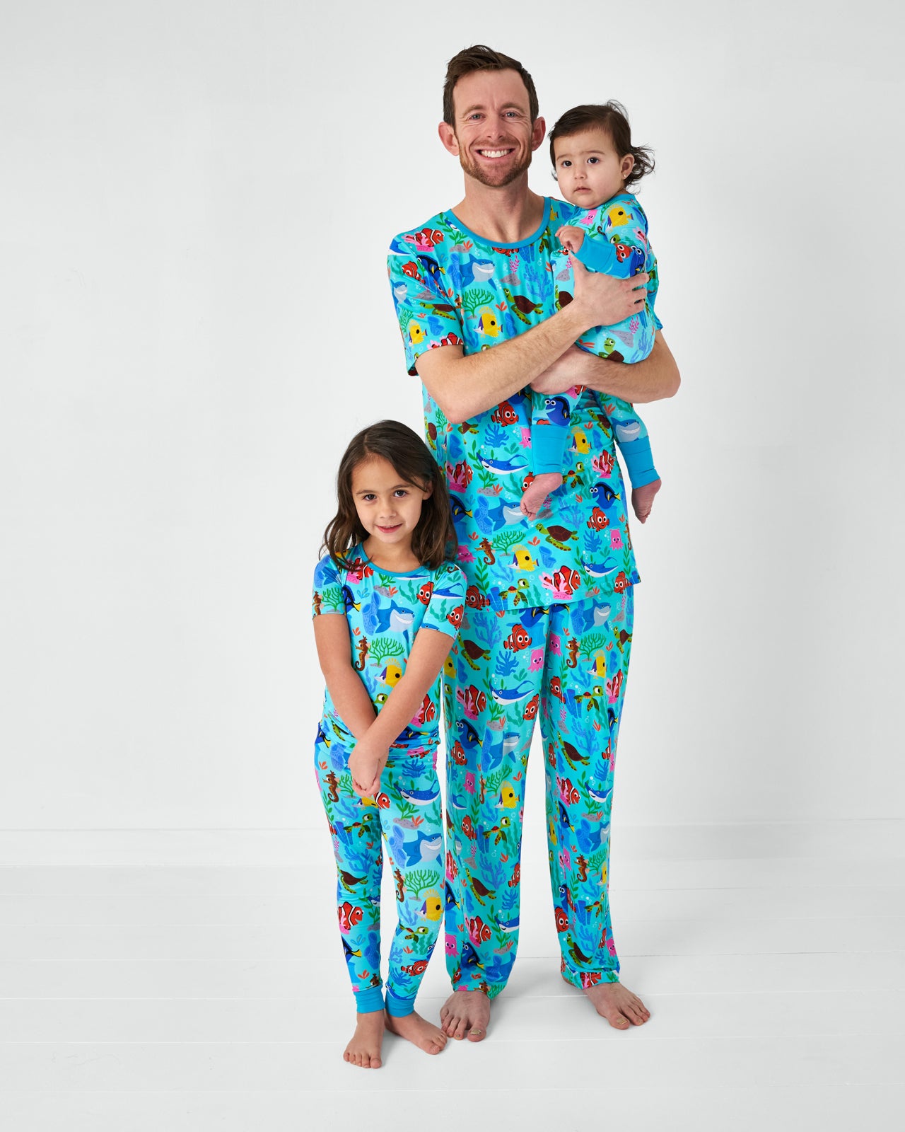 Father and two kids wearing matching Pixar Nemo's Reef