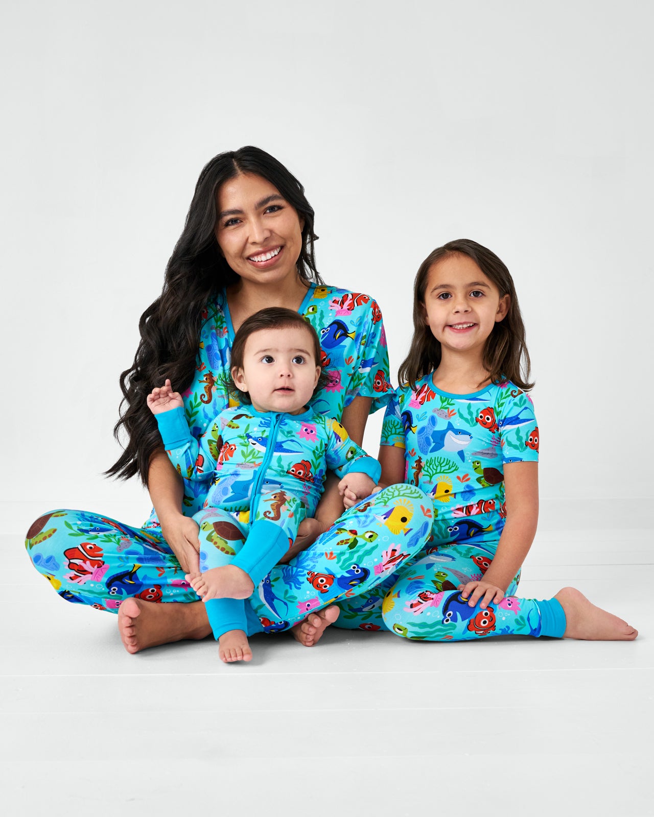 Mother and two children wearing matching Nemo's Reef bamboo pajamas