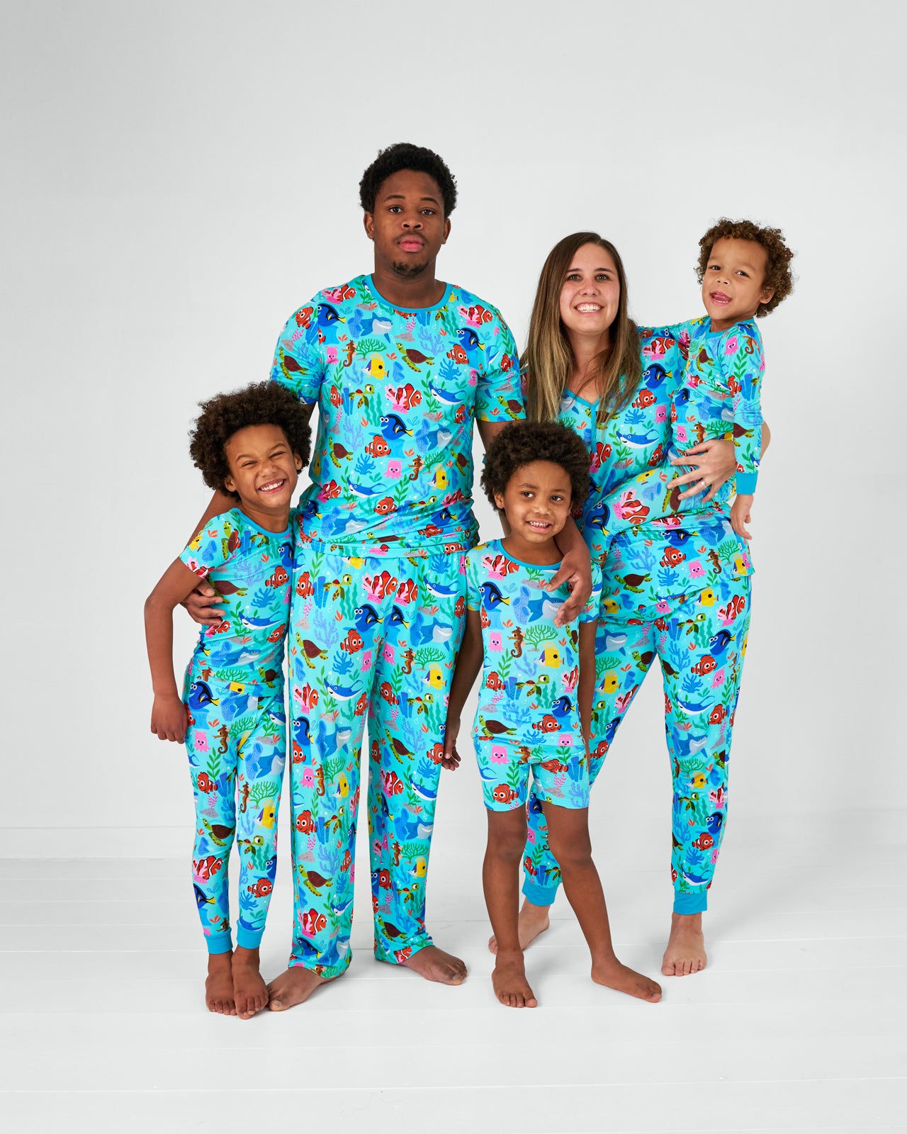Family of five wearing matching Nemo's Reef bamboo pajamas
