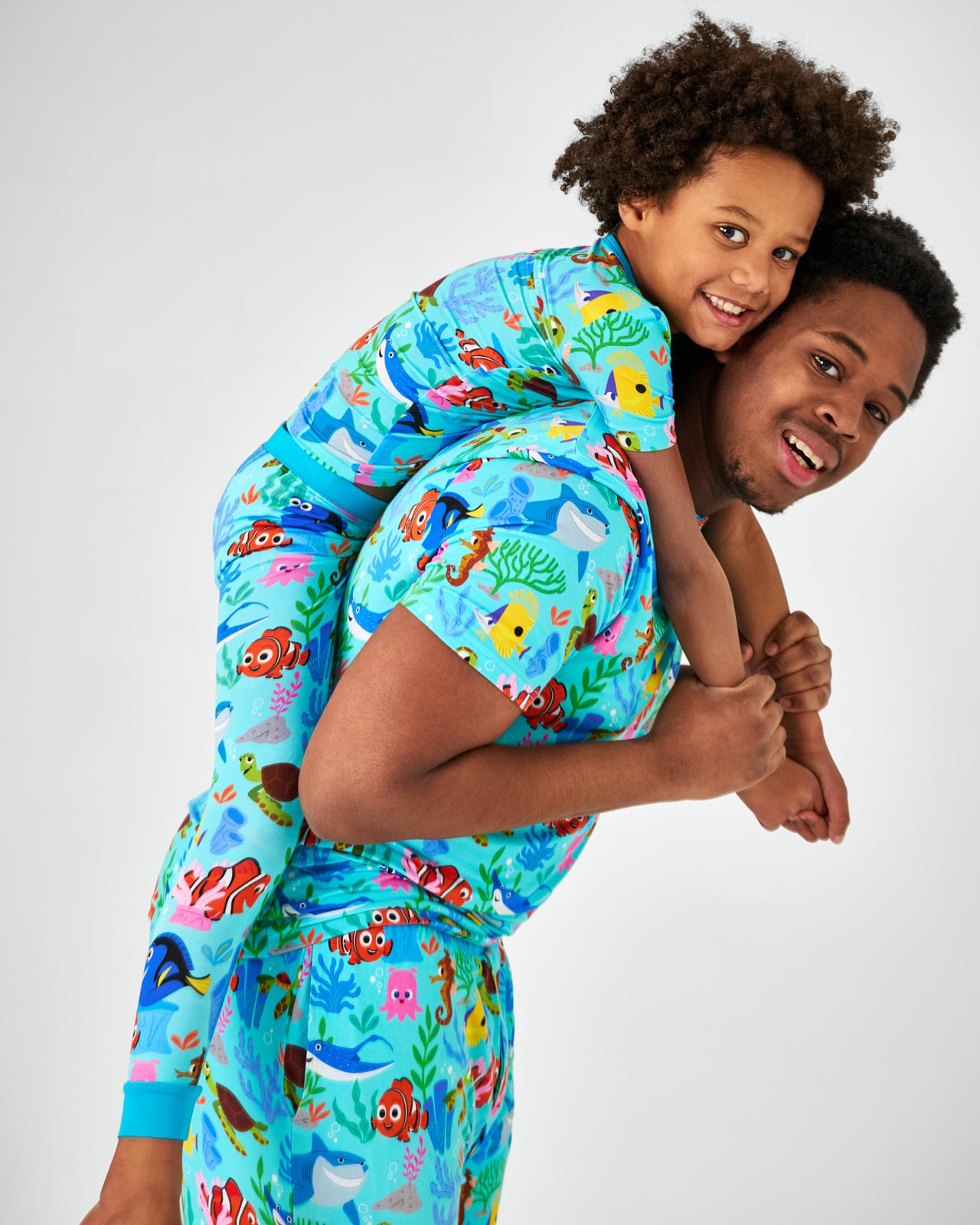 Father and son wearing matching Nemo's Reef bamboo pajama sets