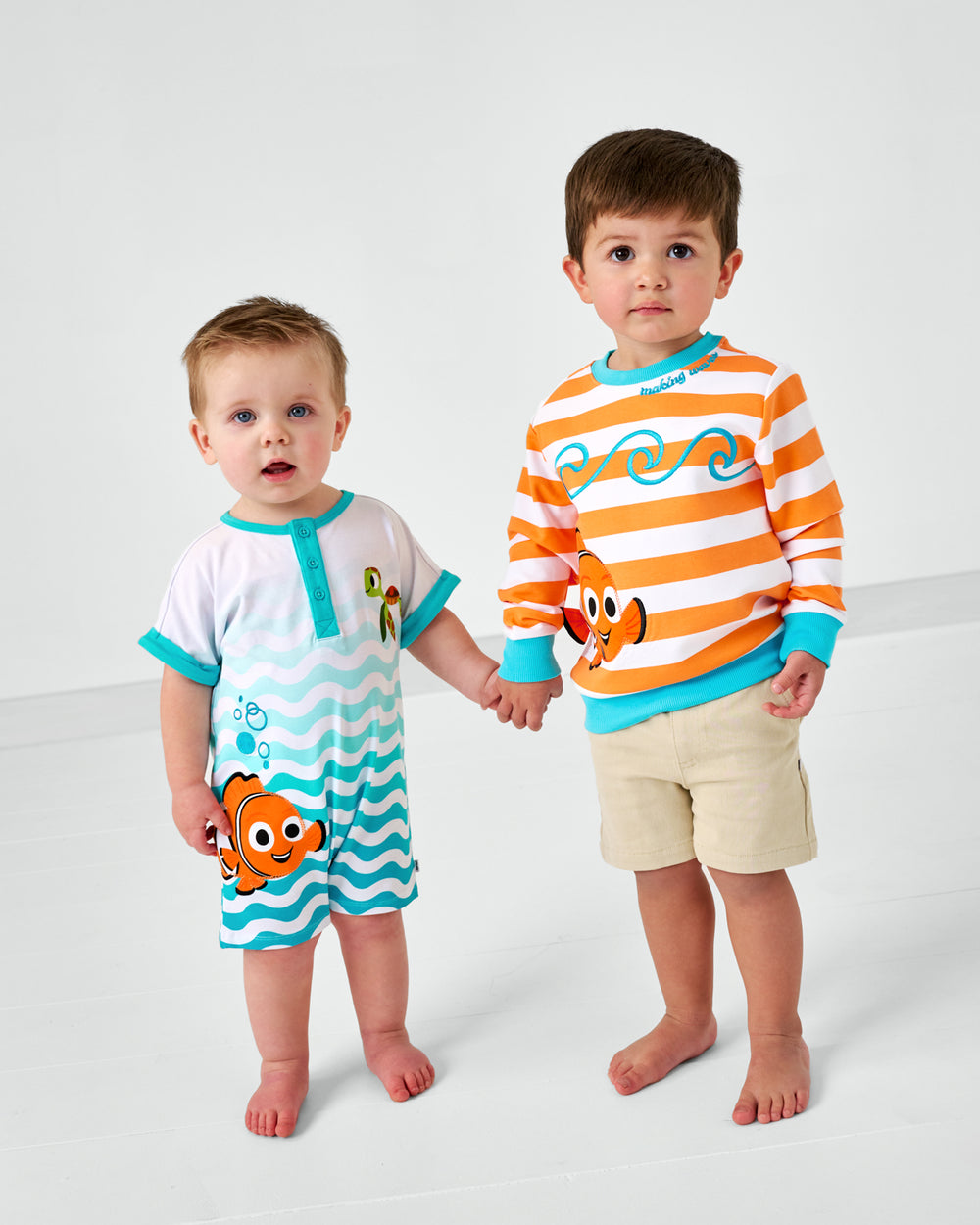 Two children holding hands wearing Finding Nemo Play styles