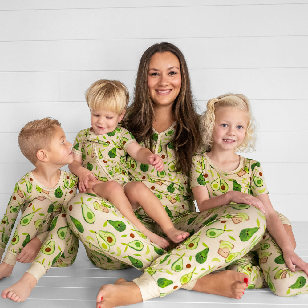 Image of a woman and her three children wearing matching Avocado Toast pjs. Mom is wearing women's Avocado Toast pj top and matching pj pants and her children are wearing zippy and two piece styles.