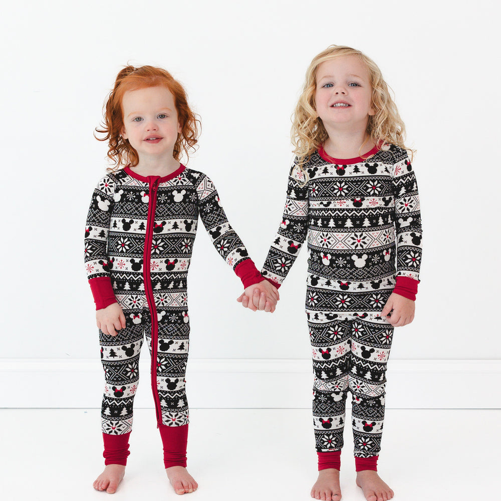 two children holding hand wearing Mickey Fair Isle pjs in zippy and two piece pj sets