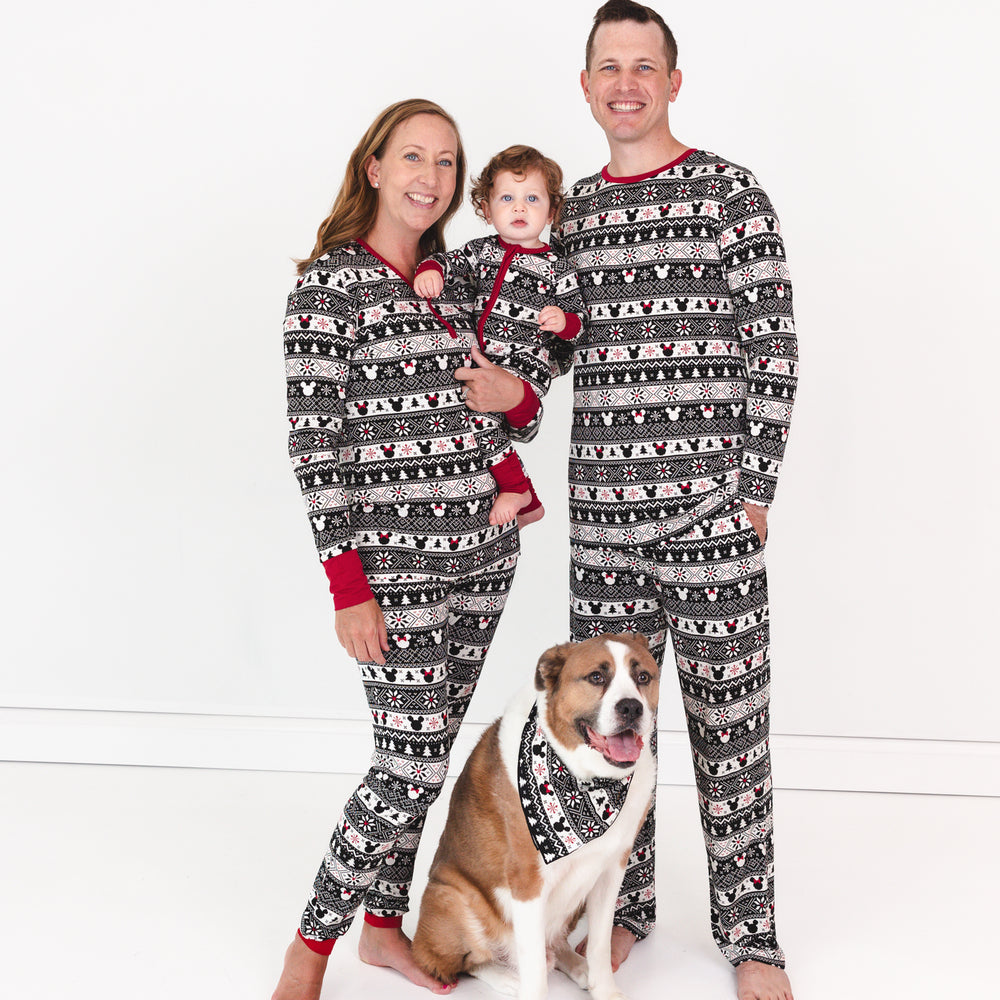 Family of three and their dog wearing matching Mickey Fair Isle pjs in men's and women's two piece styles and a child wearing a zippy. Their dog is wearing a matching pet bandana. 