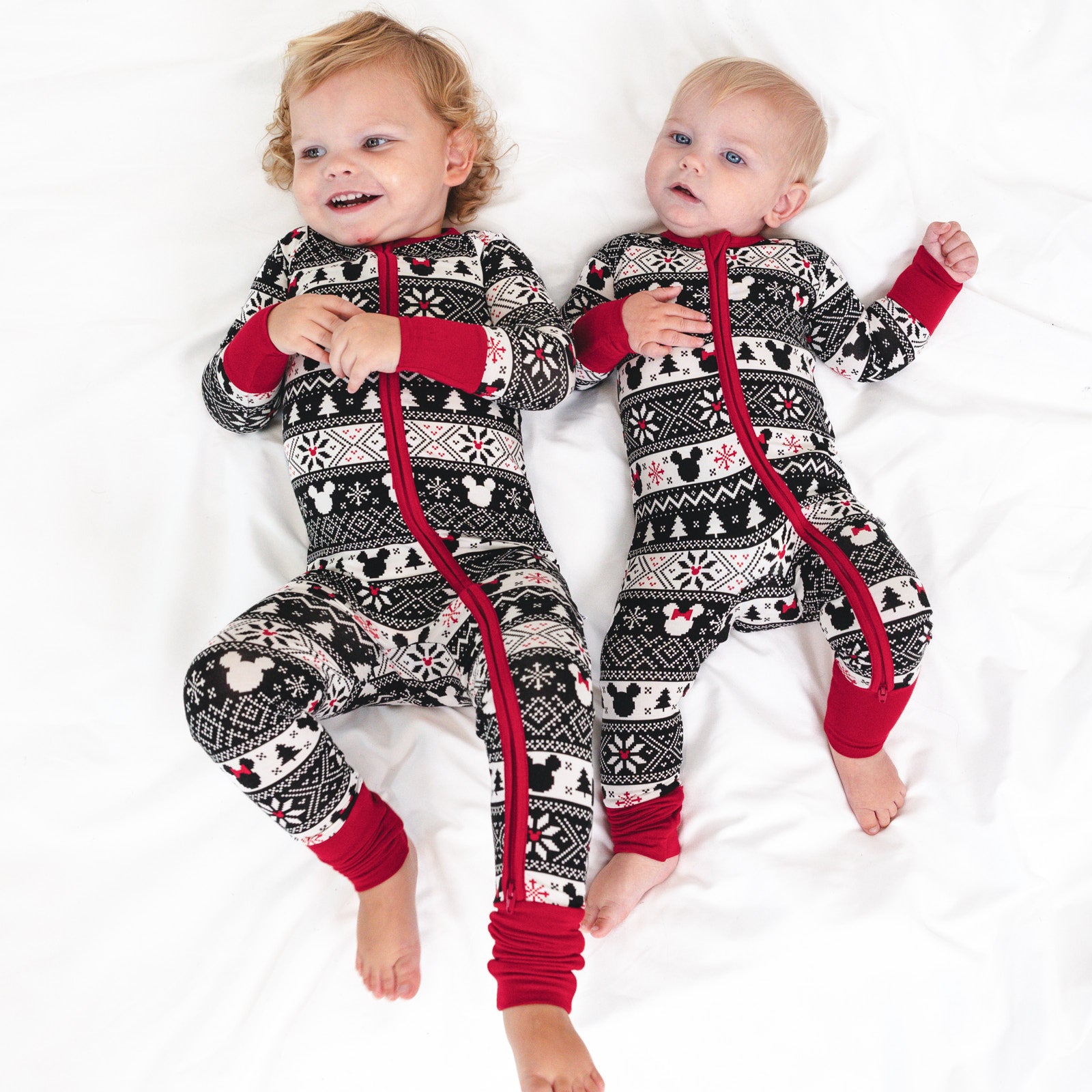 two children on a bed wearing matching Mickey Fair Isle zippies