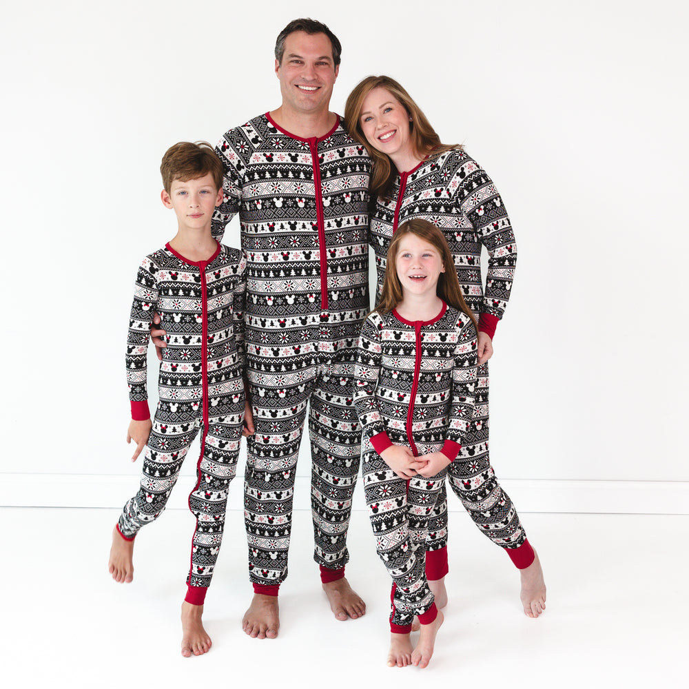 Family of four posing together matching Mickey Fair Isle zippies in men's, women's, and children's styles