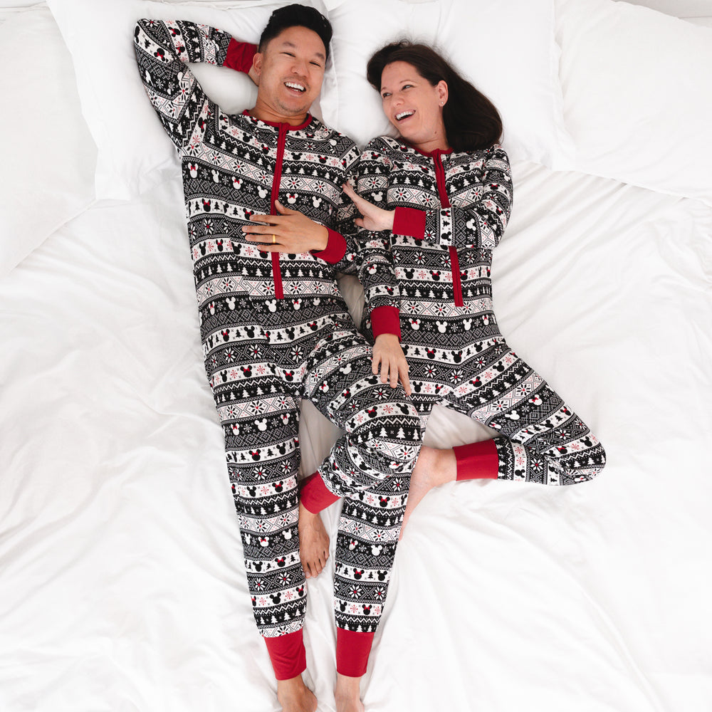 man and woman cuddling on a bed wearing matching Mickey Fair isle adult zippies