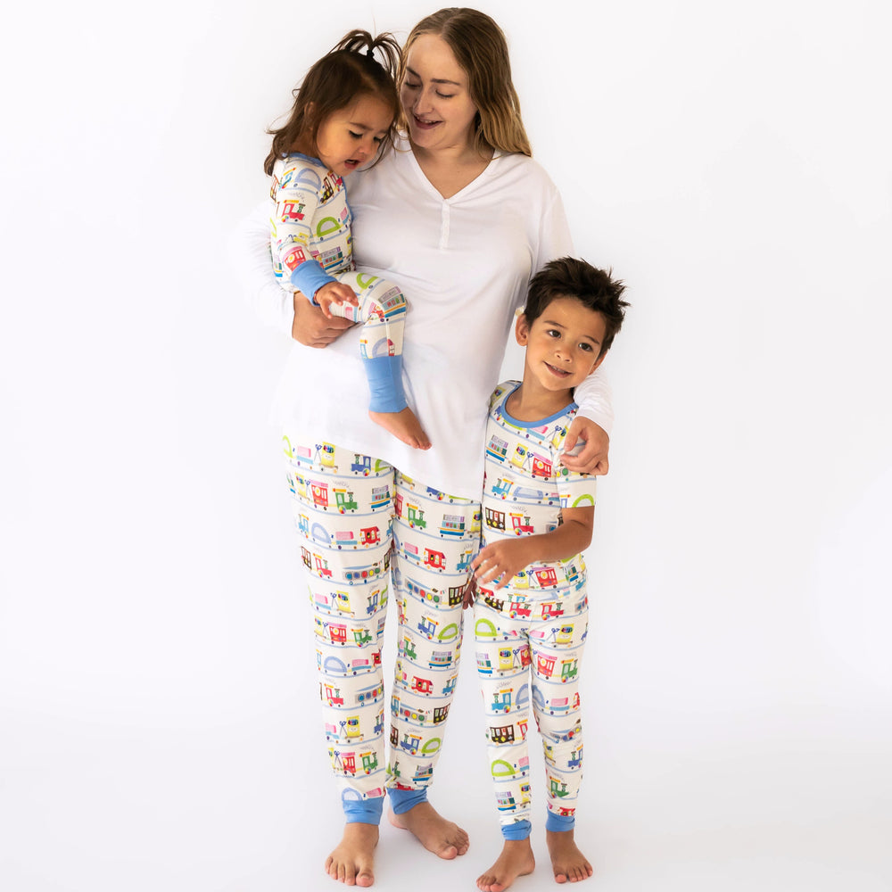 Mother and two children together wearing matching Education Express Pajamas. Mom is wearing Women's Education Express Pants and Bright White Women's Short Sleeve Pajama Top. Children are wearing the Education Express Zippy and Education Express Two-Piece Short Sleeve Pajama Set.