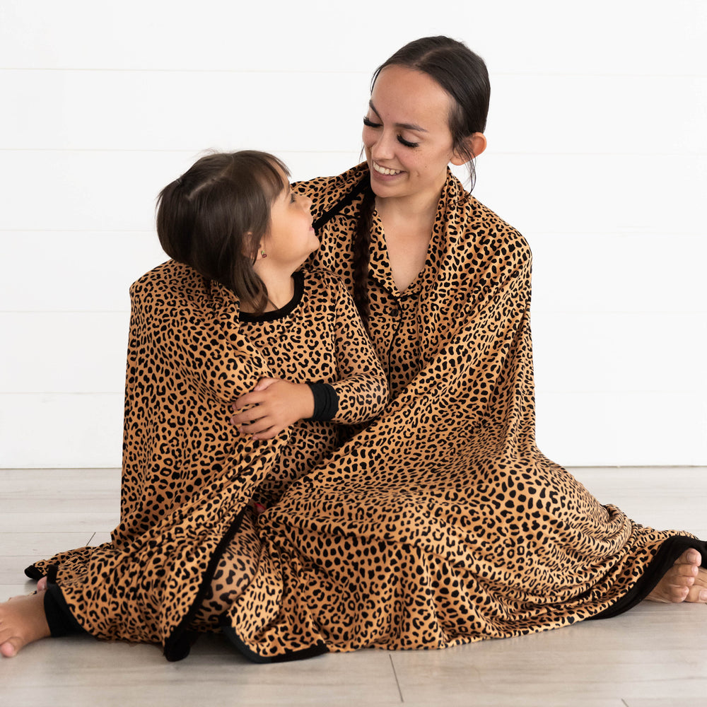 Mother and daughter are wrapped in the Classic Leopard Oversized Cloud Blanket®