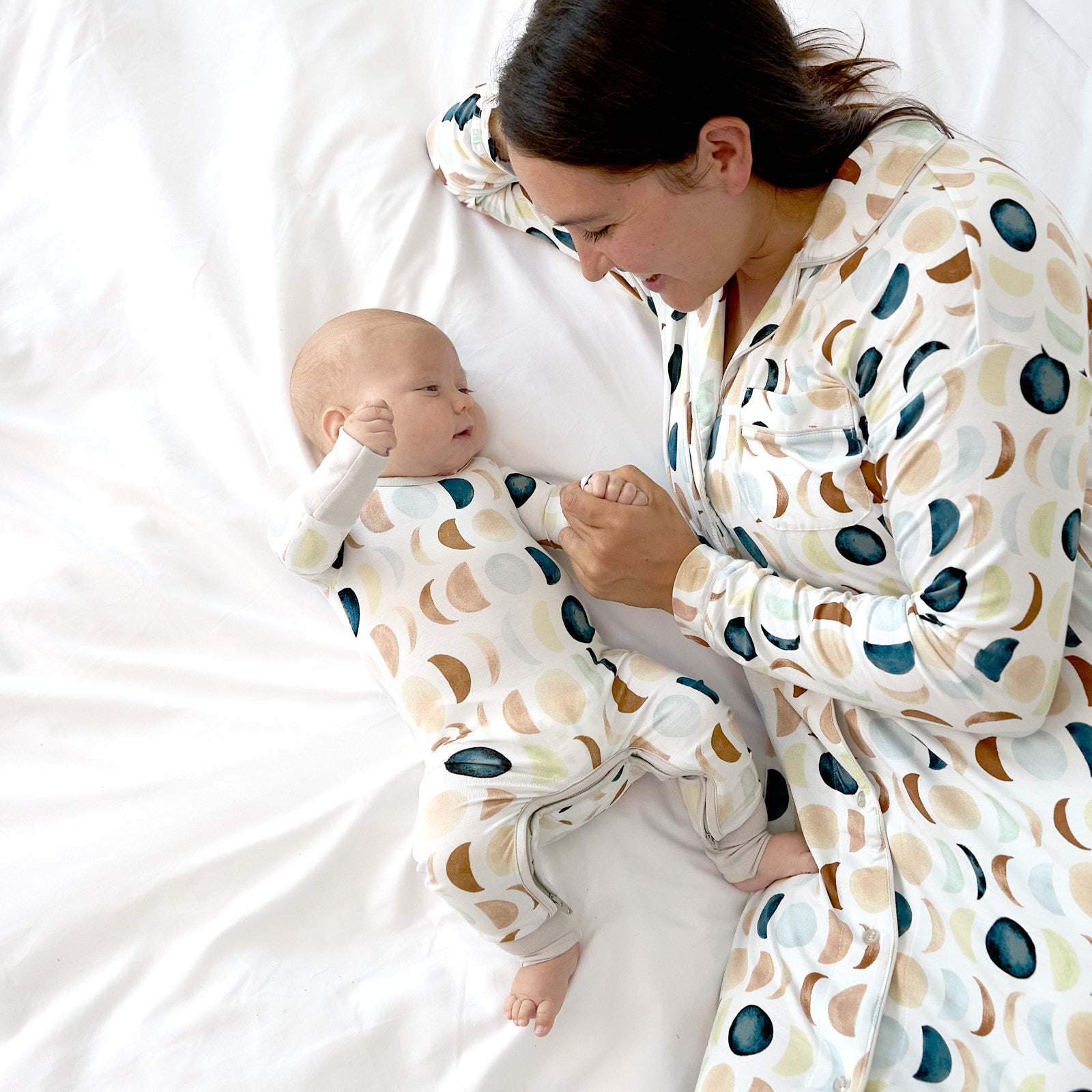 Mother and newborn wearing matching Luna Neutral sleep styles