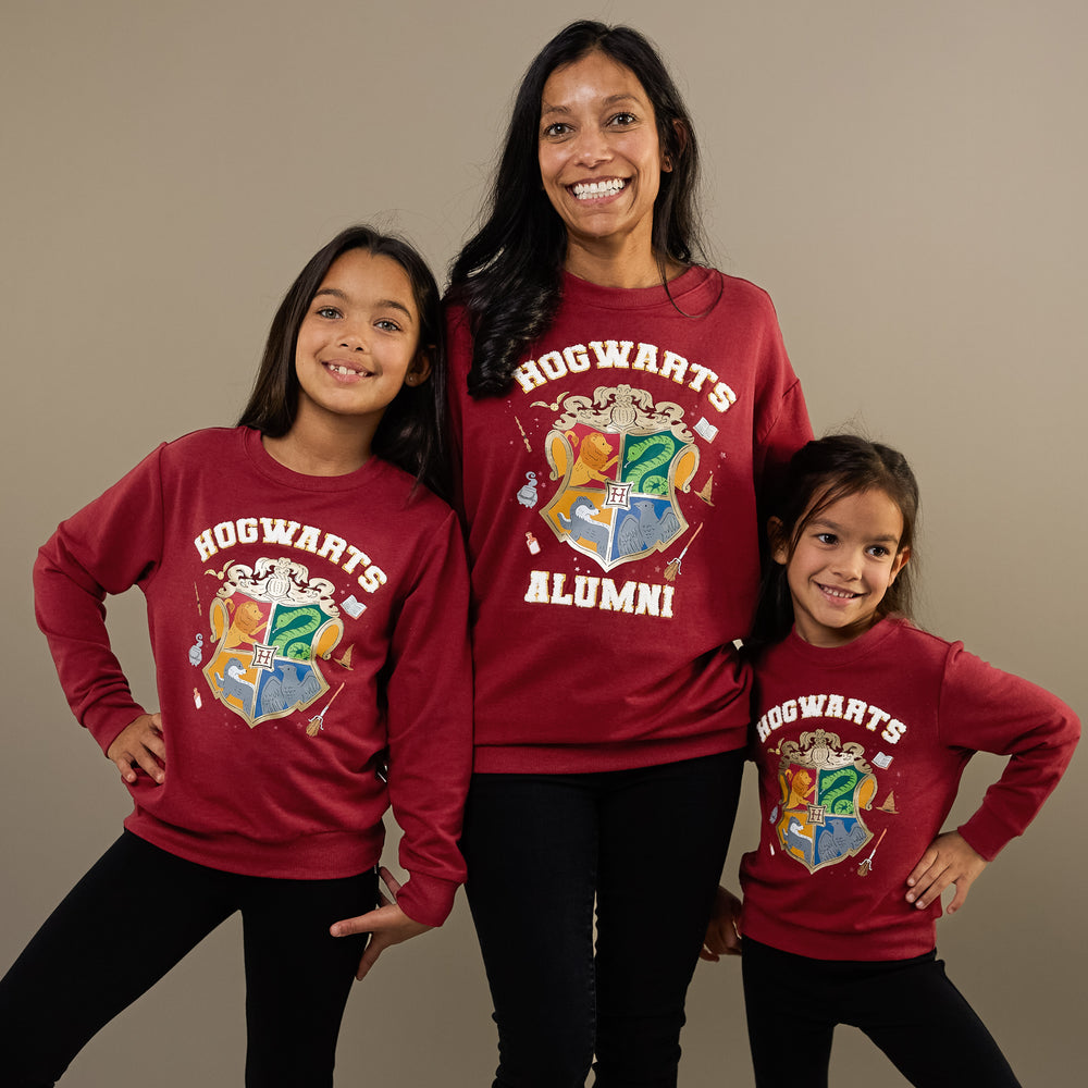 Mother and two daughters wearing matching Hogwarts Crewneck Sweatshirts