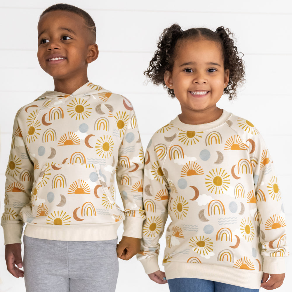 Close up image of two children wearing matching Desert Sunrise tops