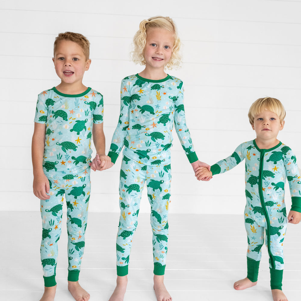 image of three children wearing Sea Turtle Friends pjs in two piece and zippy styles 