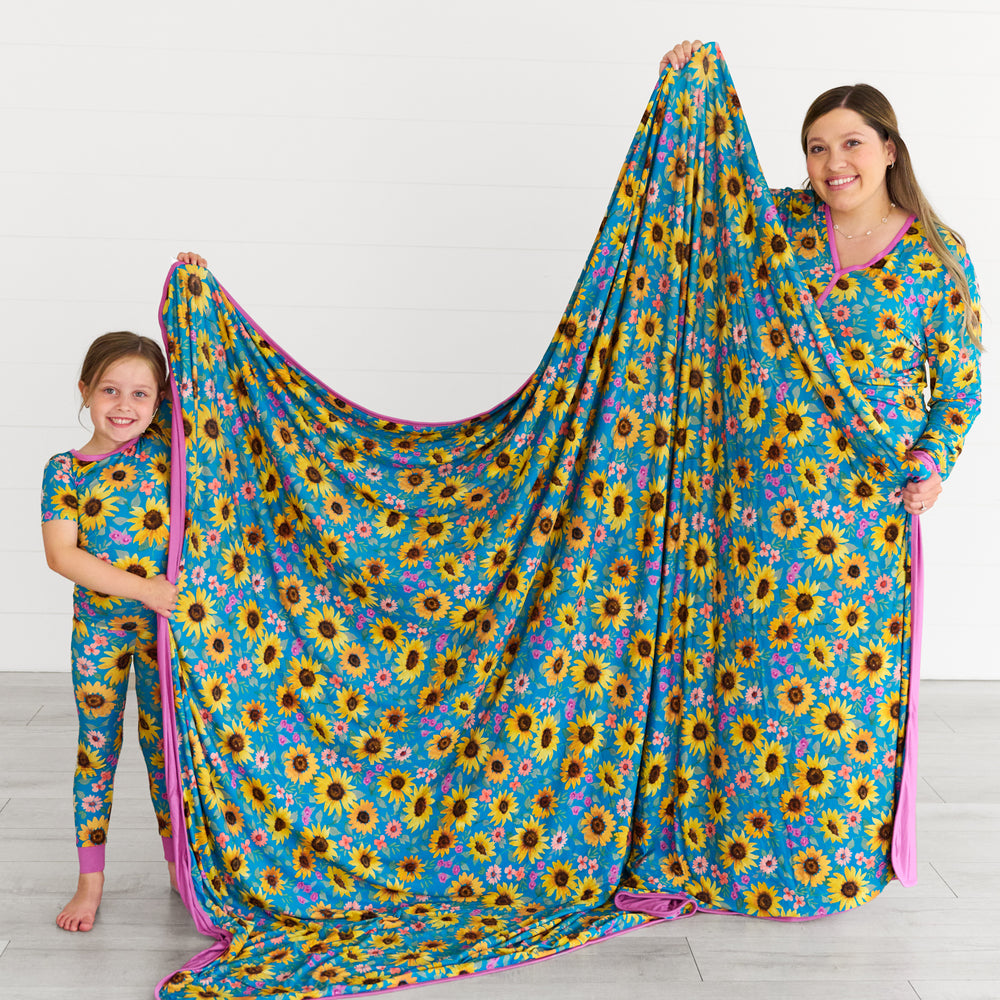 Mother and daughter displaying the size of the Sunflower Fields Oversized Cloud Blanket® 