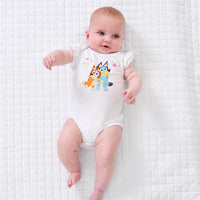 Child laying on a blanket wearing a Bluey graphic flutter bodysuit