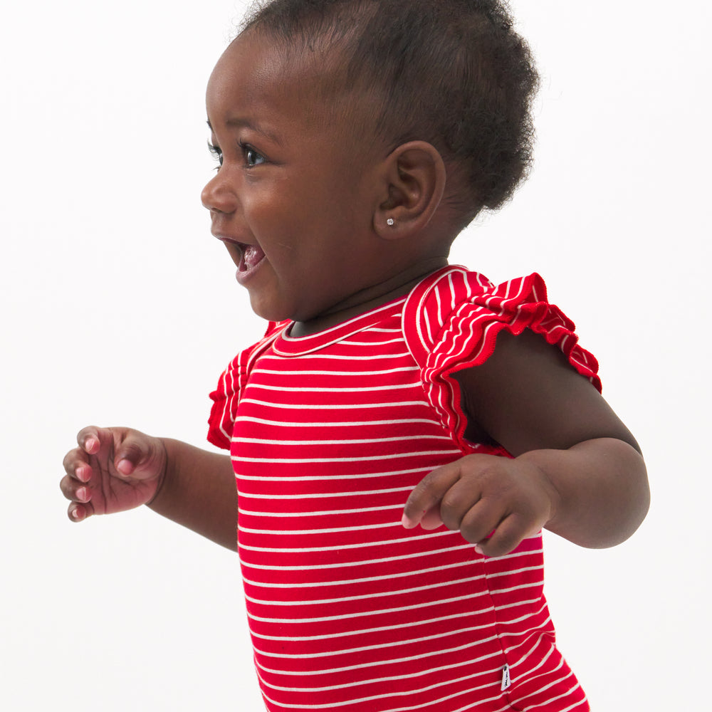 Close up image of a child wearing a Candy Red Stripes flutter bodysuit