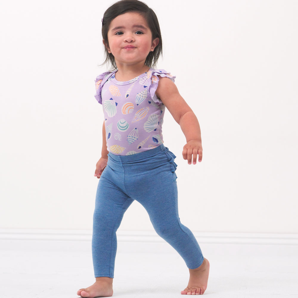 Child playing wearing a Sandy Treasures flutter bodysuit paired with Blue Heather ruffle leggings